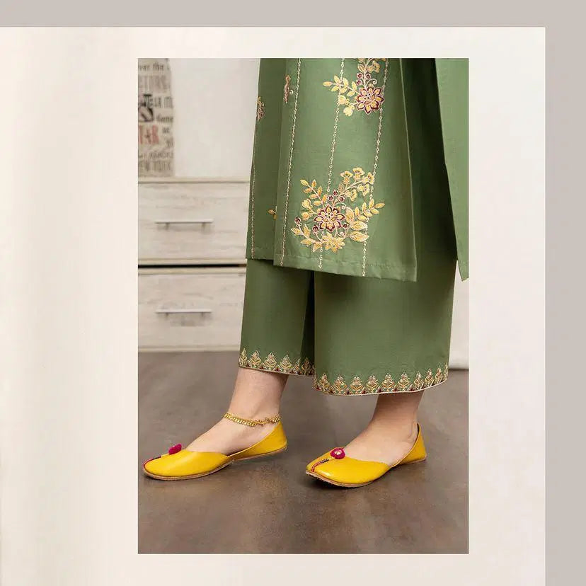 Unstitched embroidered suit for women in green with floral embroidery paired with yellow traditional flats