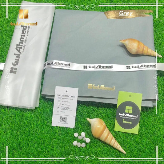 Grey men's unstitched cotton suit fabric set by Look Loom with Gul Ahmed labels tags buttons and shells on green background