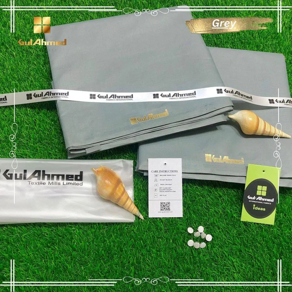 Look Loom grey fabric set with tags buttons and packaging men's unstitched cotton suit displayed on green grass