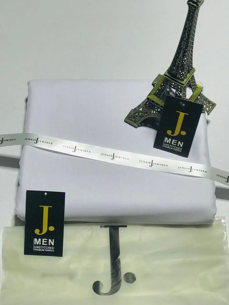 Look Loom white men's unstitched wash and wear suit fabric set with J men tags and Eiffel Tower prop