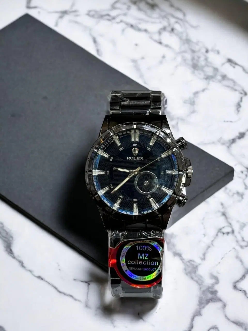 Look loom stylish men's wristwatch with black dial and metal strap on marble surface