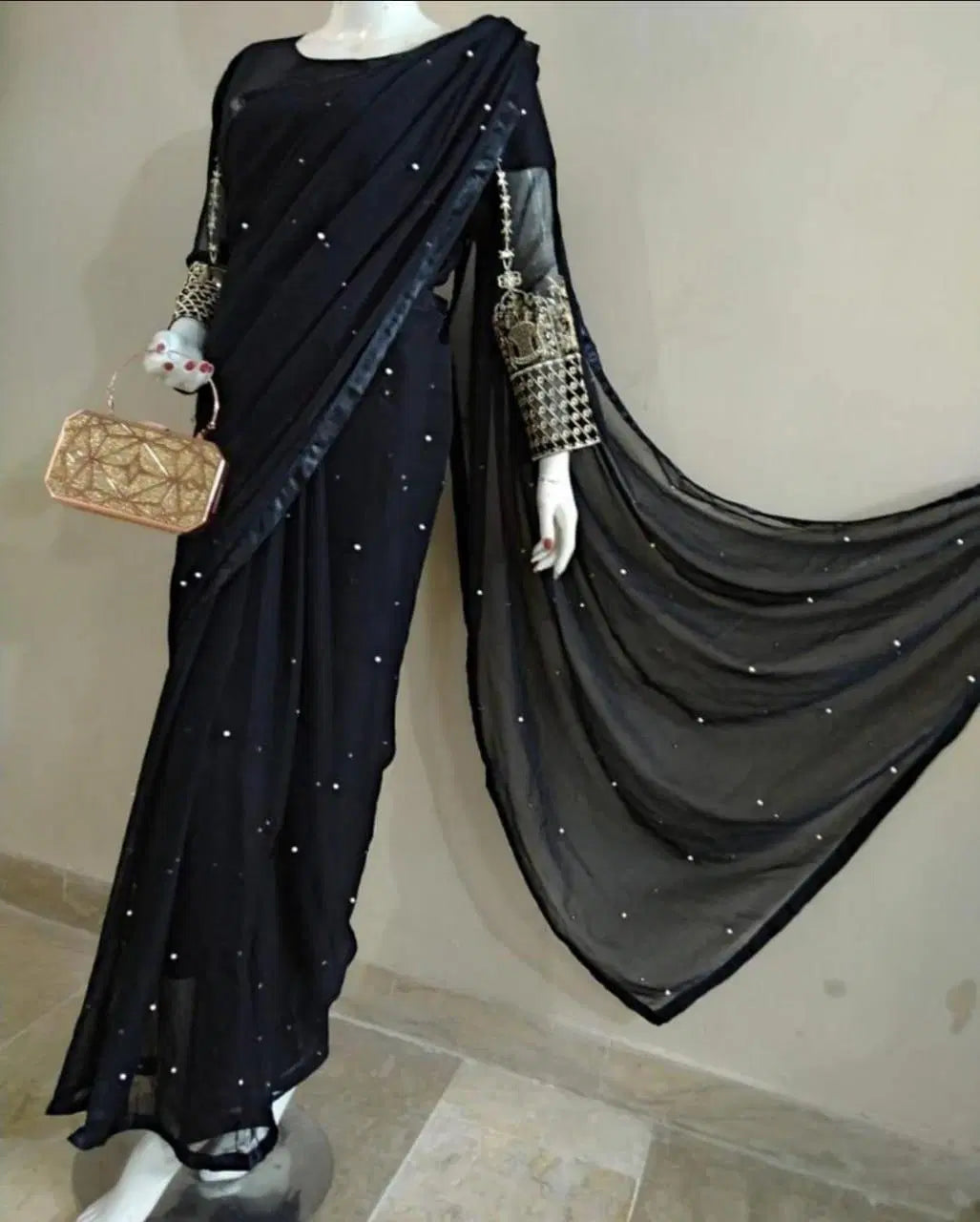 Look Loom women suit featuring black crinkle chiffon saree with scattered sequins sheer pallu and embellished blouse