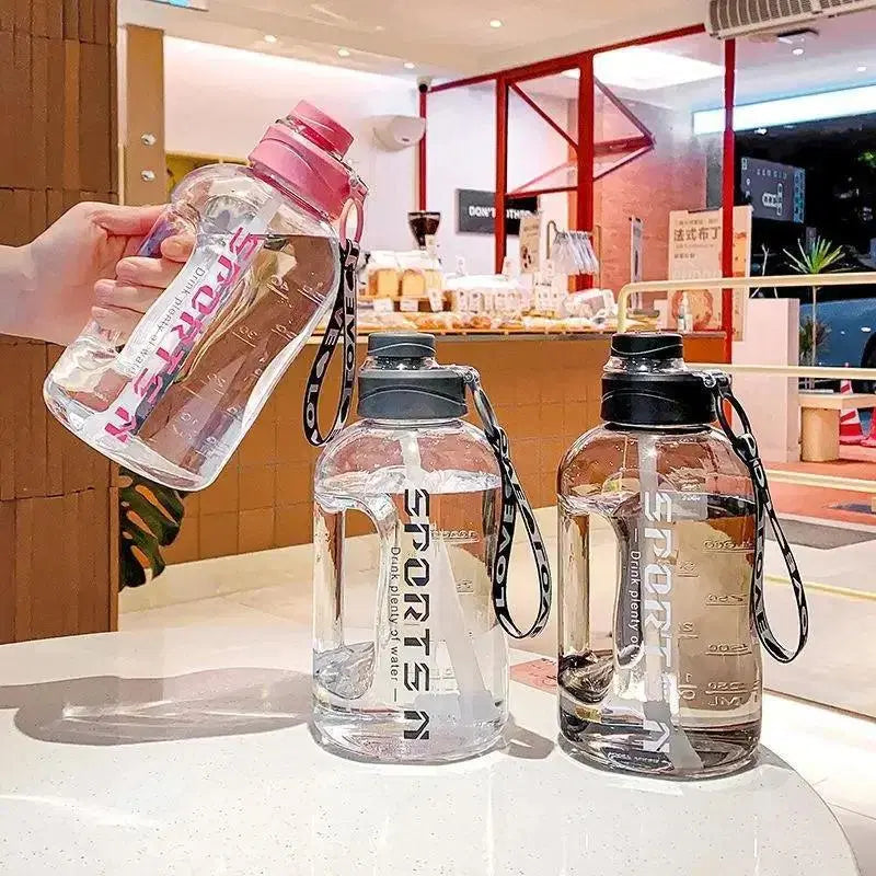 Look Loom 2 liter gym water bottle in clear with pink and black lids, portable with wrist strap