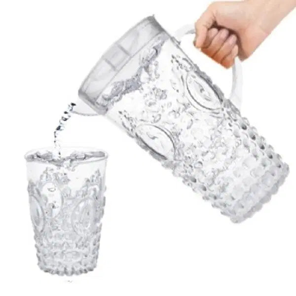 Look Loom crystal glass jug set pouring water into a matching textured glass tumbler